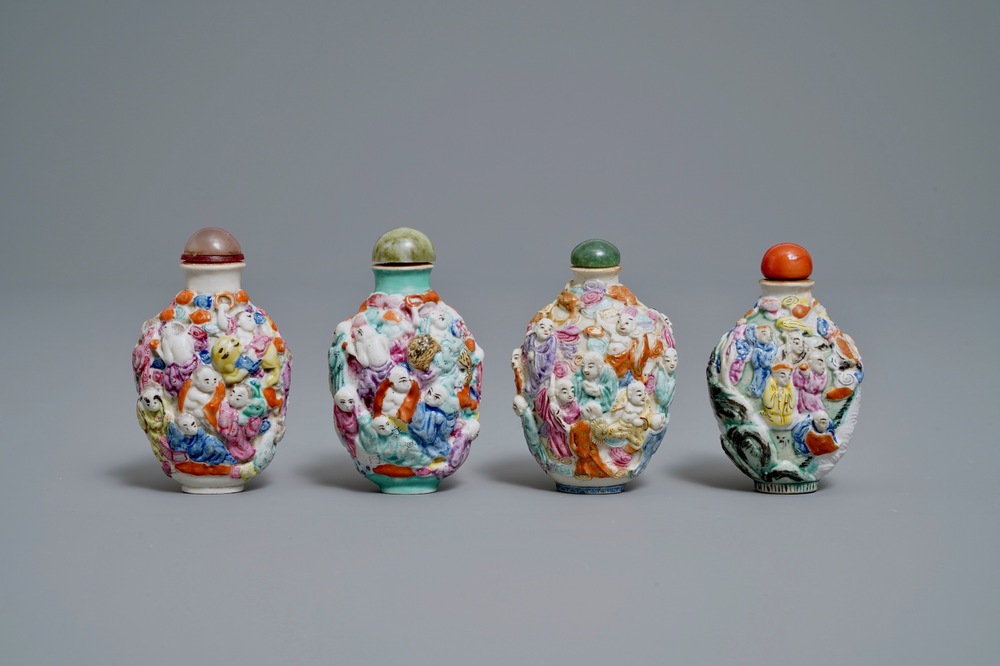 Four Chinese famille rose porcelain relief-decorated snuff bottles, 19th C.